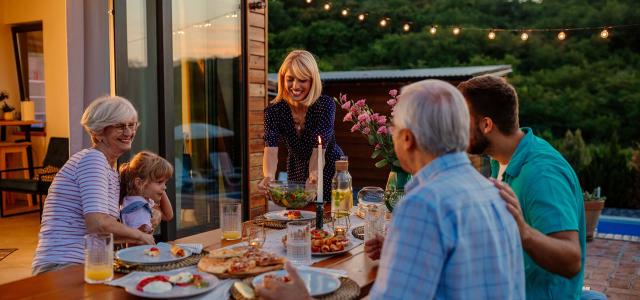 Intergenerational Family Socializing at the Dining Table Outside